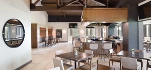 Modern country club dining area with wood beam features