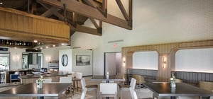 Modern country club dining area with wood beam features