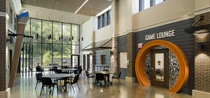 Modern community engagement space featuring a game lounge entrance