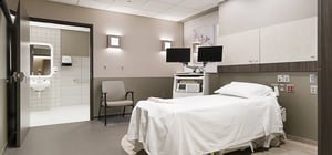 OB patient room with modern style and large en-suite bathroom.