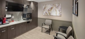 Family lounge room for waiting and relaxing with seating, mini kitchen and a TV