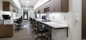 Modern healthcare clinic nurse's station with desks and computers