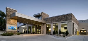 Modern healthcare clinic exterior drive up view at dusk