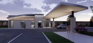 Architectural rendering of the exterior entrance of a modern medical facility at dusk