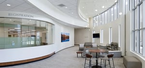 Modern ER entry corridor with receptionist desks and waiting area