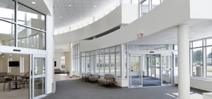 Modern ER entry corridor with receptionist desks and waiting area