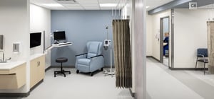 Modern healthcare clinic infusion bay with reclining chair and tv