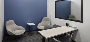 Blank Honors Center testing room with desk and arm chairs
