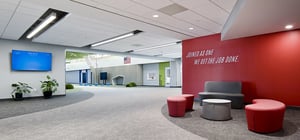 Modern elementary school commons area with sitting area and school branding