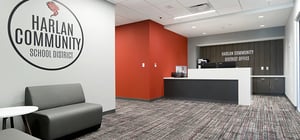 Modern school district office with reception desk and seating